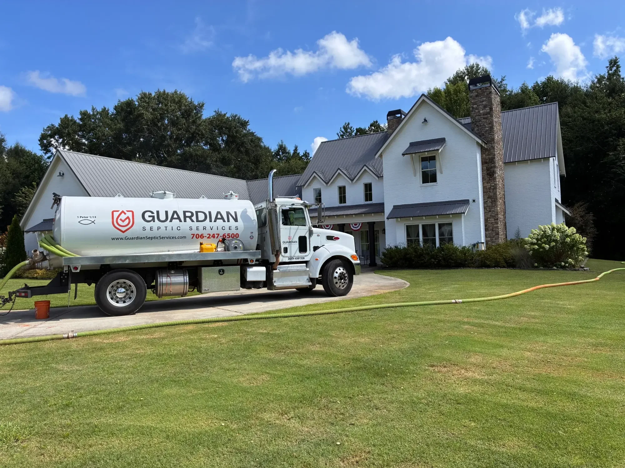 Guardian Septic Services vacuum truck pumping a septic tank at a Jefferson, Georgia home